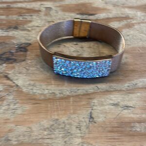 Woman’s rose gold band and fake diamond’s bracelet